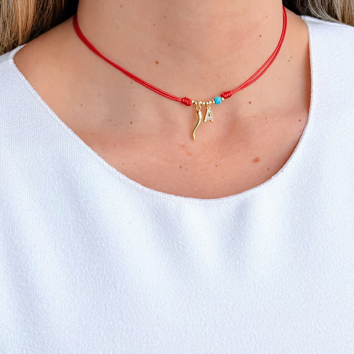 Red cord necklace with gold Cornicello charm and CZ initial pendant.