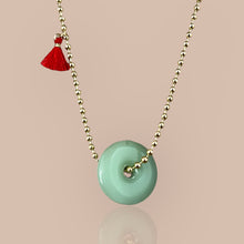 Load image into Gallery viewer, Gold beaded chain necklace adorned with a jade disc pendant, symbolizing tranquility and protection.
