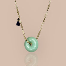 Load image into Gallery viewer, Gold beaded chain necklace adorned with a jade disc pendant, symbolizing tranquility and protection.
