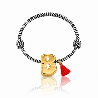 Black and white paracord initial bracelet with oversized gold-plated letter and red tassel