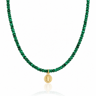 Close-up of an 8mm Saint Benedict medal pendant in 14K gold filled, suspended from small green malachite beads.


