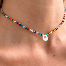 Load image into Gallery viewer, Model wearing personalized initial name necklace with Mother of Pearl and vibrant beads.
