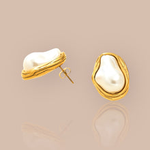 Load image into Gallery viewer, Side view of baroque pearl earrings with intricate details and elegant gold accents.
